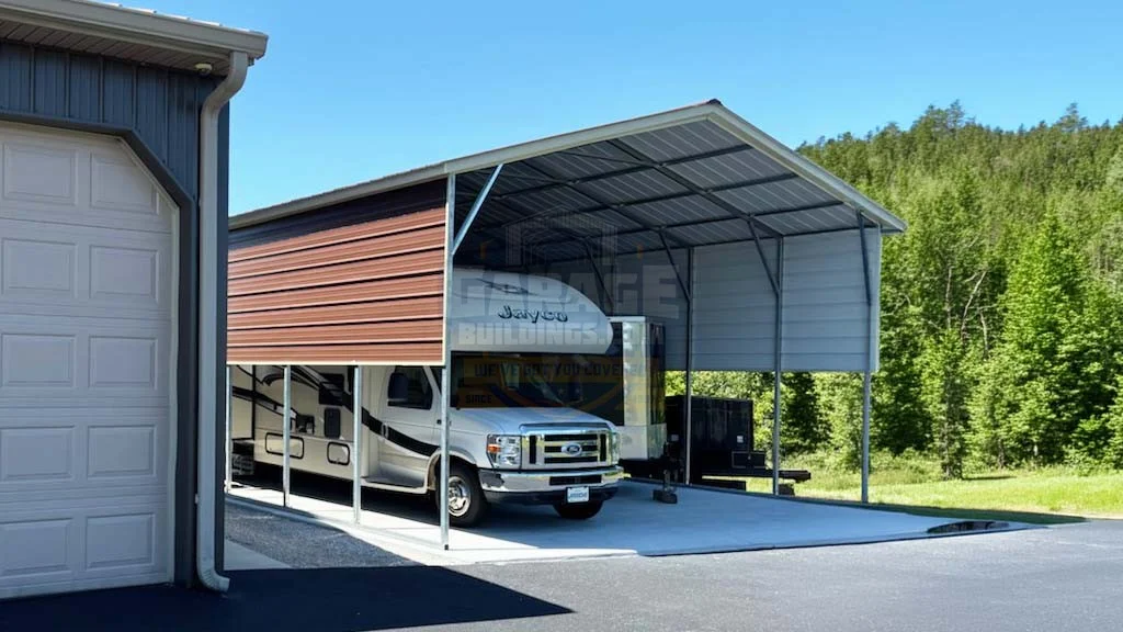 RV parked under a metal carport next to a garage