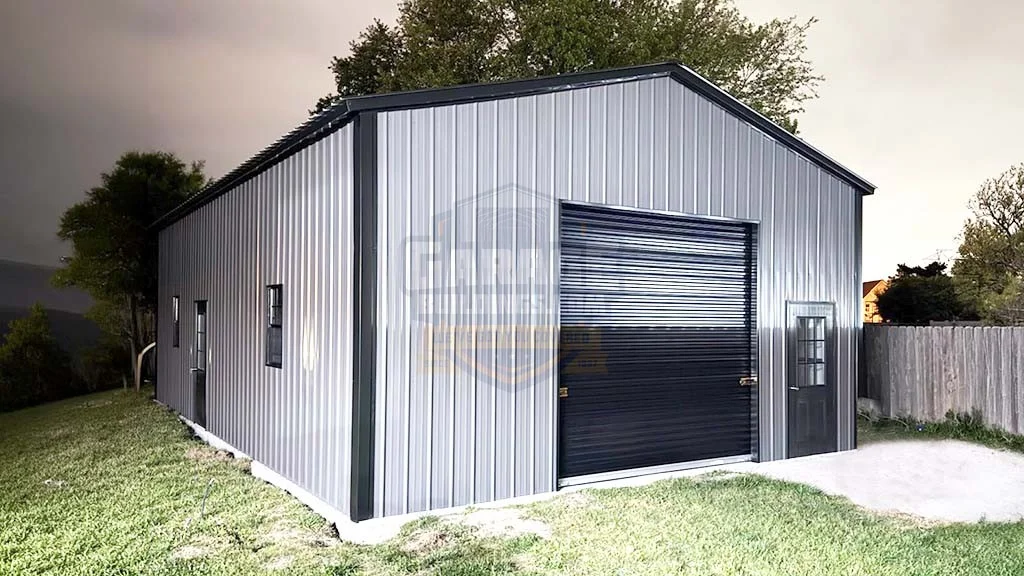 Metal shed with a large roll-up door and surrounded by grass