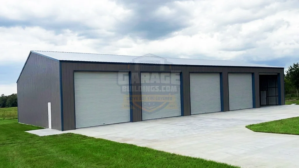 Large steel garage building with three roll-up doors and a paved area