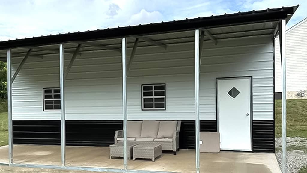 Single-story metal building with a covered porch and patio furniture