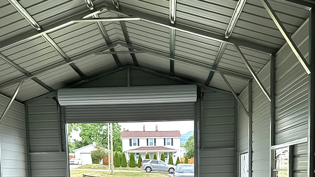 Interior view of a metal garage with an open door and outside visibility