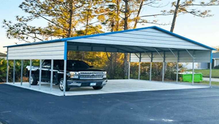Carport sheltering a black truck, surrounded by trees and pavement