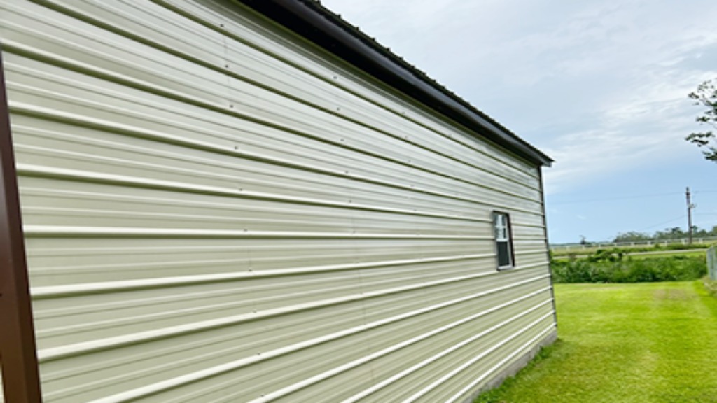 Side view of a building with metal siding and a small window