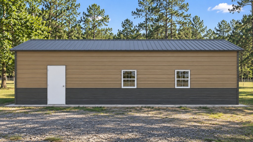 Single-story building with tan and dark gray exterior, surrounded by trees